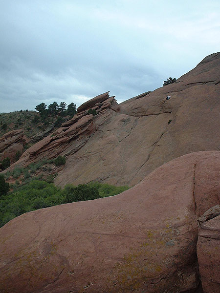 Big rock wall with two people climbing it (almost there).jpg 80.4K